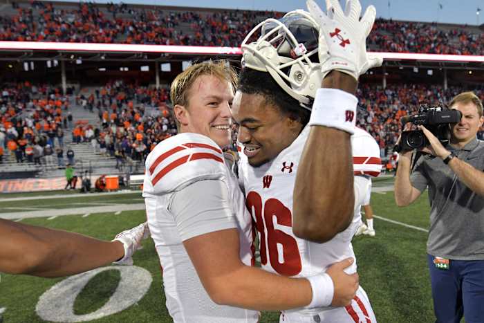 Oct 21, 2023; Champaign, Illinois, USA; Wisconsin Badgers quarterback Braedyn Locke (18) celebrates a 25-21 win over the Illinois Fighting Illini during the second half at Memorial Stadium. Mandatory Credit: Ron Johnson-USA TODAY Sports